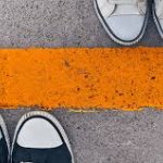 yellow line in the middles with only a pair of shoes showing on each side on April 22, 2026